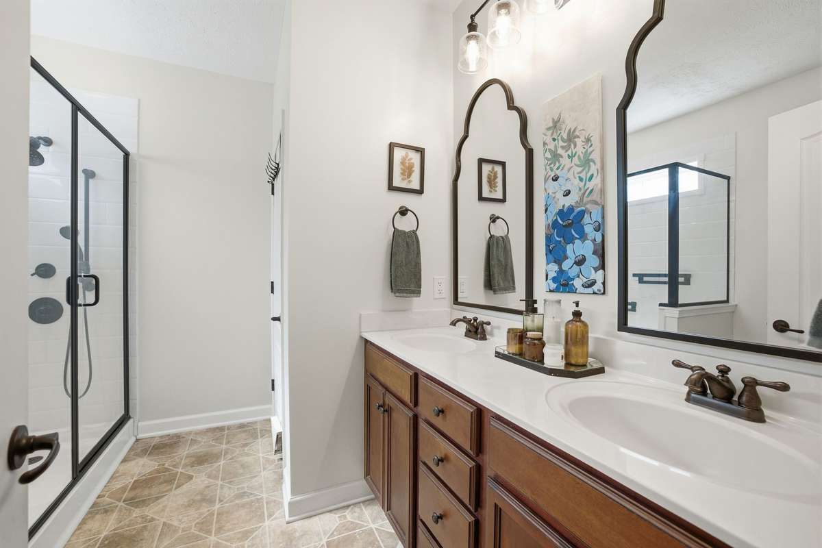 Wow! Look at this lovely bath. An extra large step-in shower, dual vanities and a linen closet.