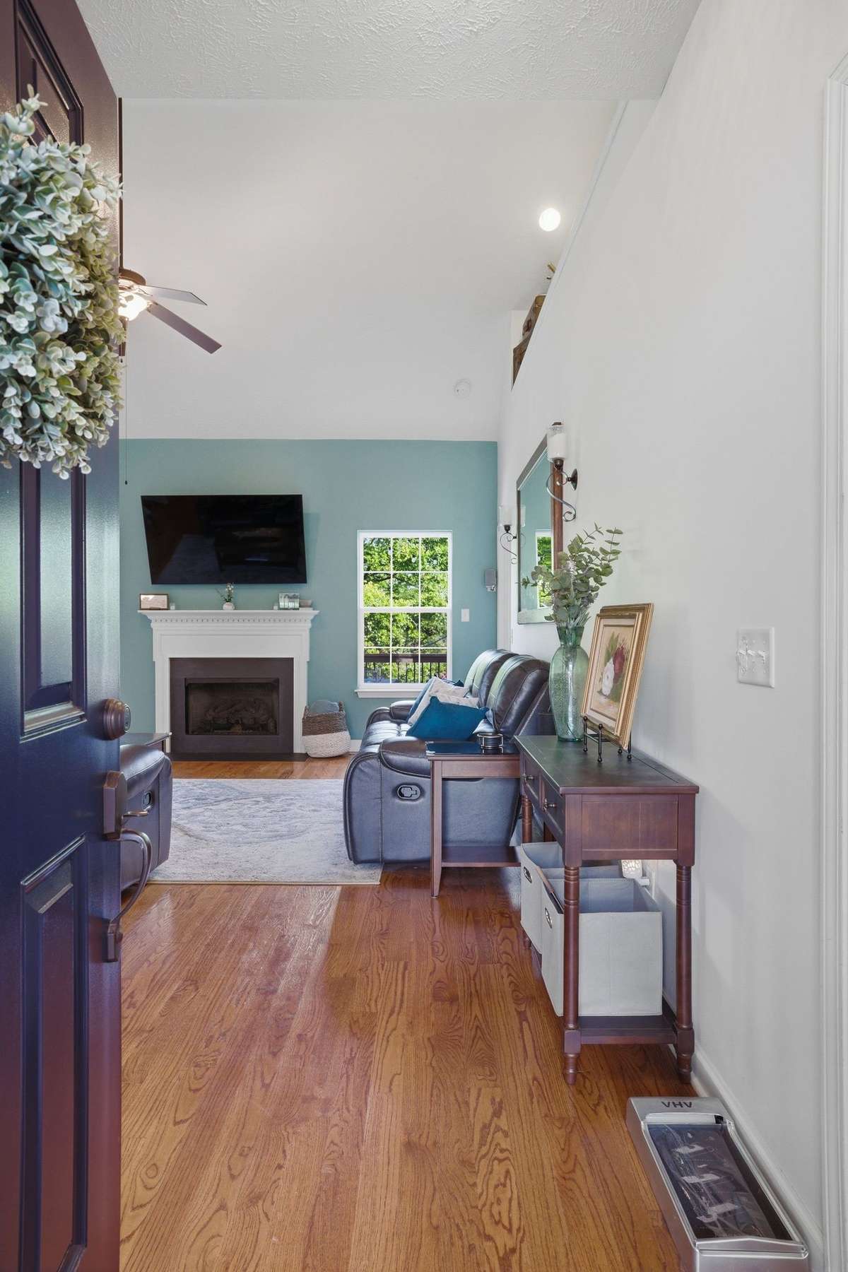 Welcome your guests into a vaulted ceiling entry with hardwoods and a cozy fireplace.