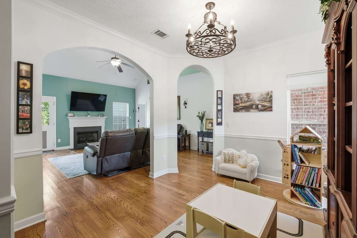 A view of the dining room open to the family room. The arches add a lovely design giving the dining room a special feel.