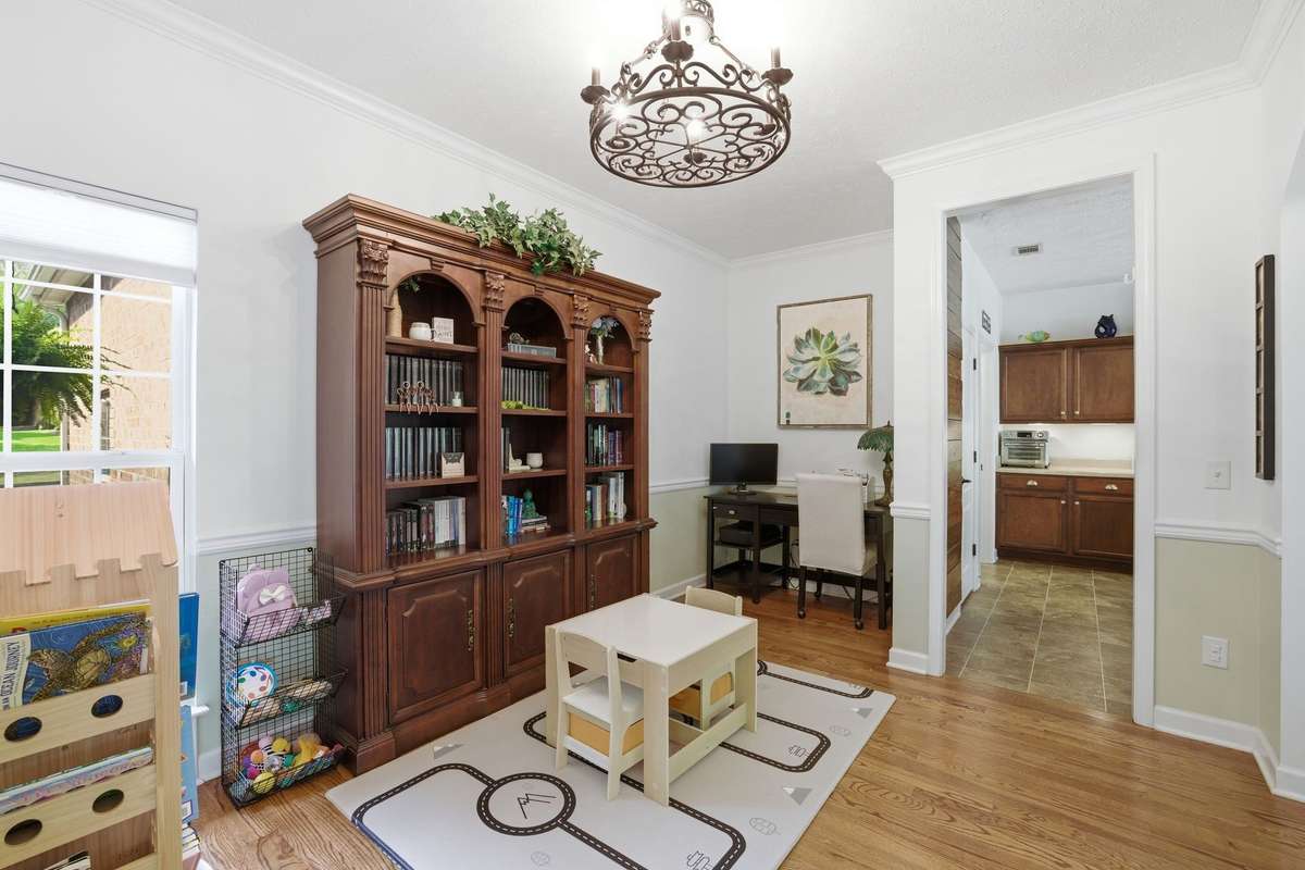 This is the formal dining space - currently used as the home office and child's playroom. Notice the bump out with the desk? This would make a lovely space for shelving, a dry wine bar or serving table for the dining room.