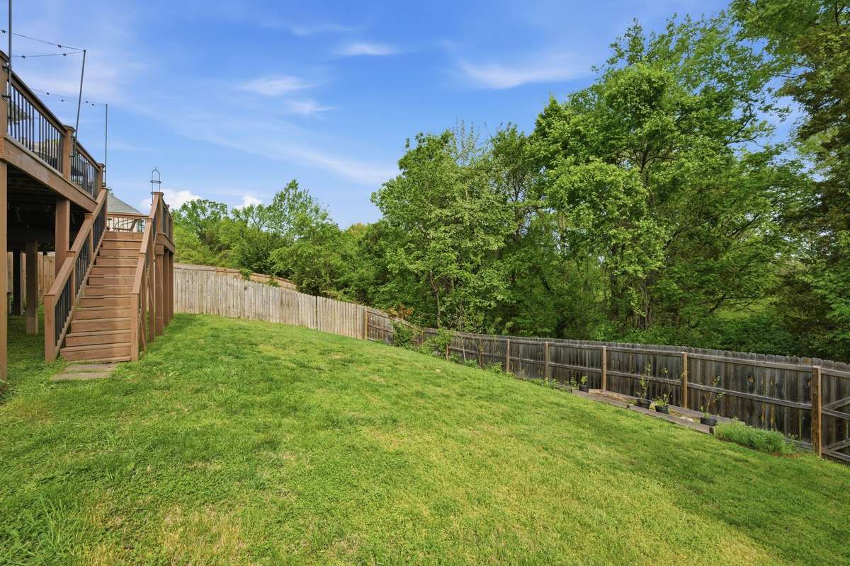 A wall of trees adds beauty and privacy - this is a backyard where you can relax and unwind.