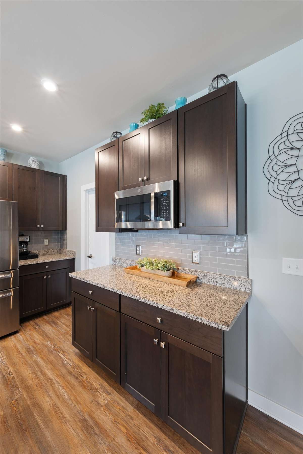 The microwave is conveniently located to maximize flow in this kitchen