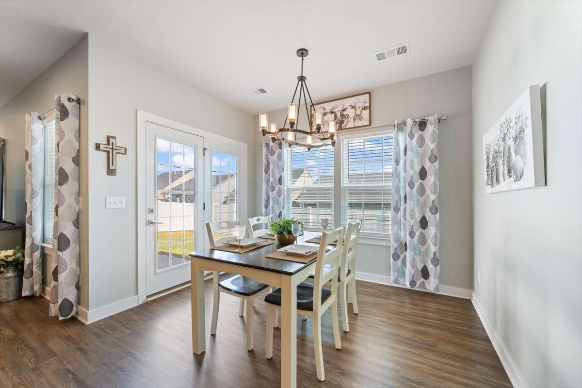 The large eating area offers abundant natural light, access to the patio for grilling, and connectivity to the kitchen and living room.