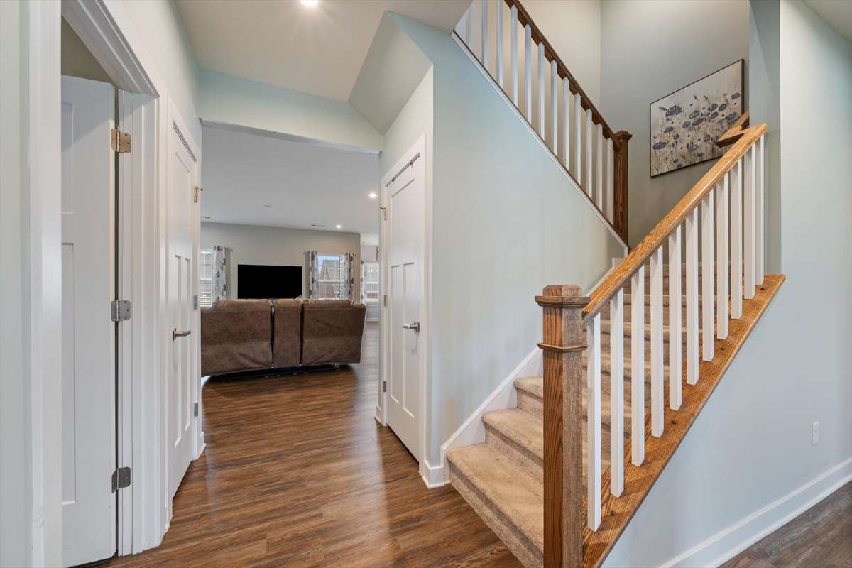 The first door on the left leads through the laundry room to the attached garage.   There are closets behind the closed doors on the right and left of the hallway.