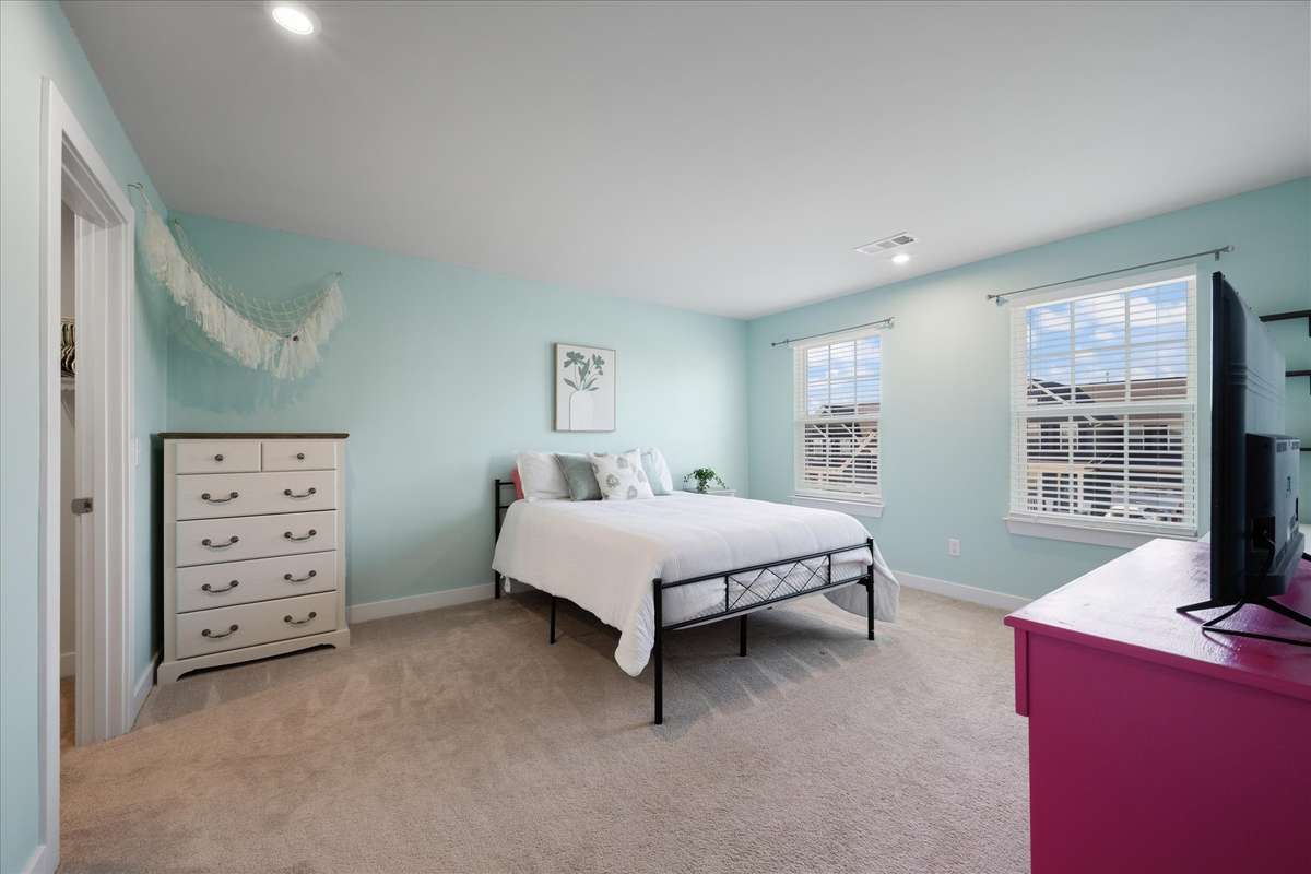 Bedroom 2 has lots of floor space, big windows, and a walk-in closet.