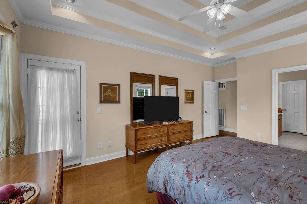 Primary bedroom has door which leads out to back covered patio