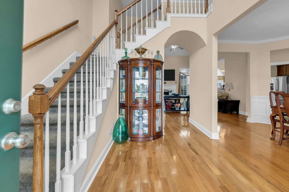 Foyer from entrance leads to formal dining room on the right side and walk through to the living room and kitchen straight ahead.