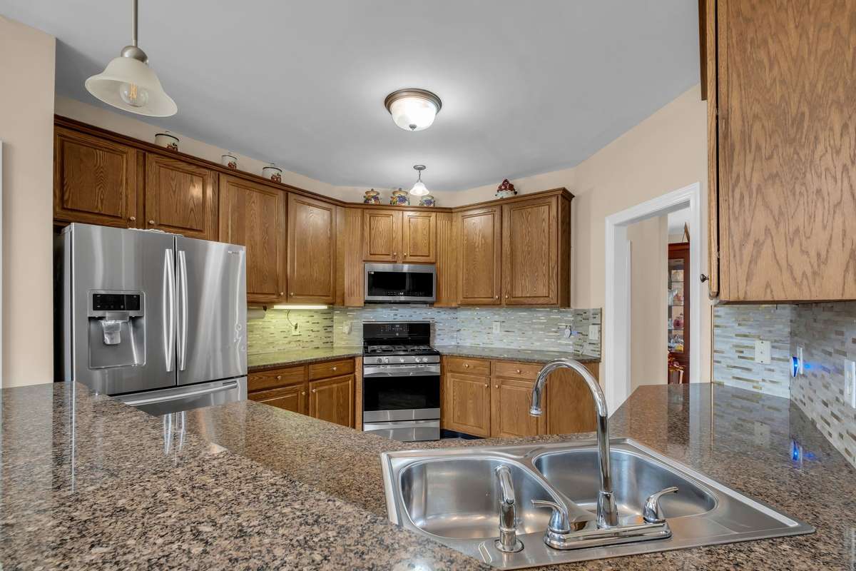 Large kitchen with stainless steel appliances, granite countertops, and plenty of cabinet space. New microwave and dishwasher. Refrigerator can stay.