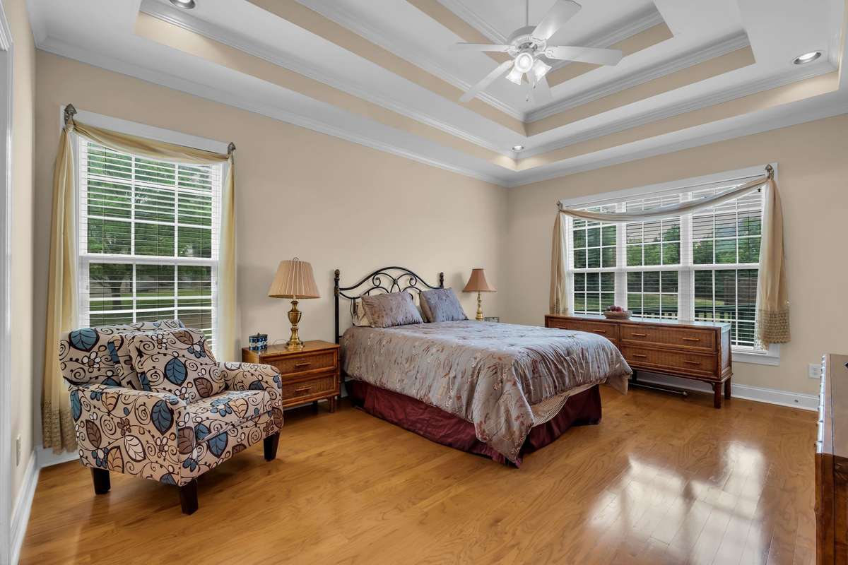 Primary Bedroom suite on first floor. Faces back of the home with attached bathroom and walk in closet.