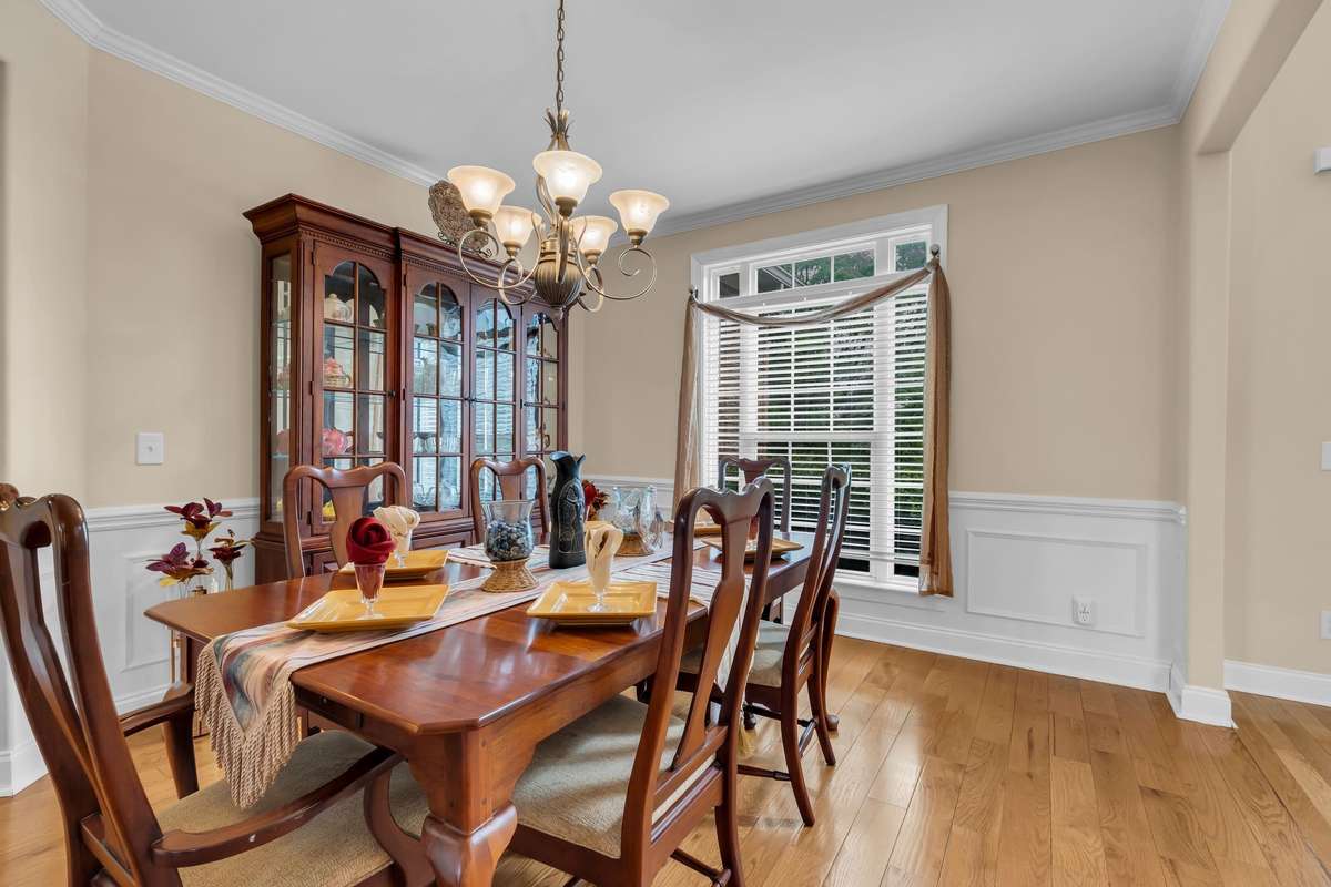 Formal dining room with wainscoting and plenty of room for large family entertaining.