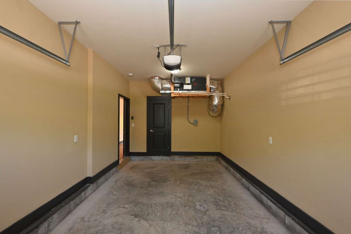 Utility Closet with hot water heater in garage