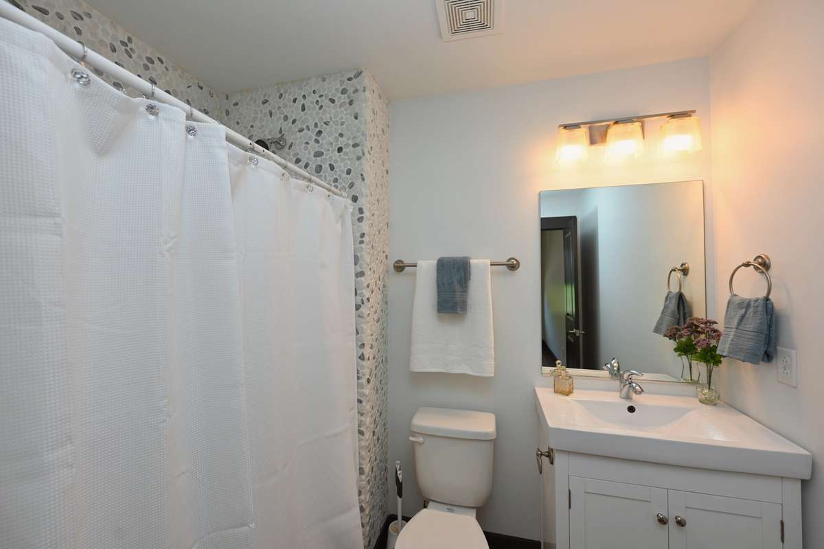Full Bathroom with Custom Rock Wall Accent in Shower