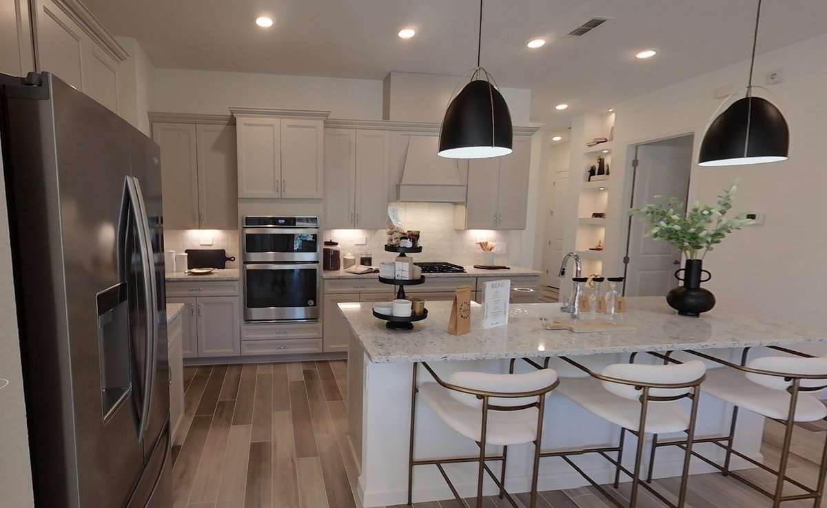 Kitchen includes GAS cooking, QUARTZ countertops, tiled backsplash & more! *photo from previously built Edison Floorplan*