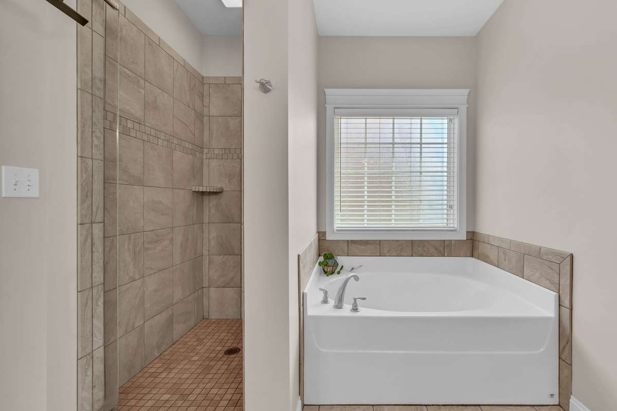 2971 Prince Dr. - Primary bathroom includes soaking tub and tile shower.