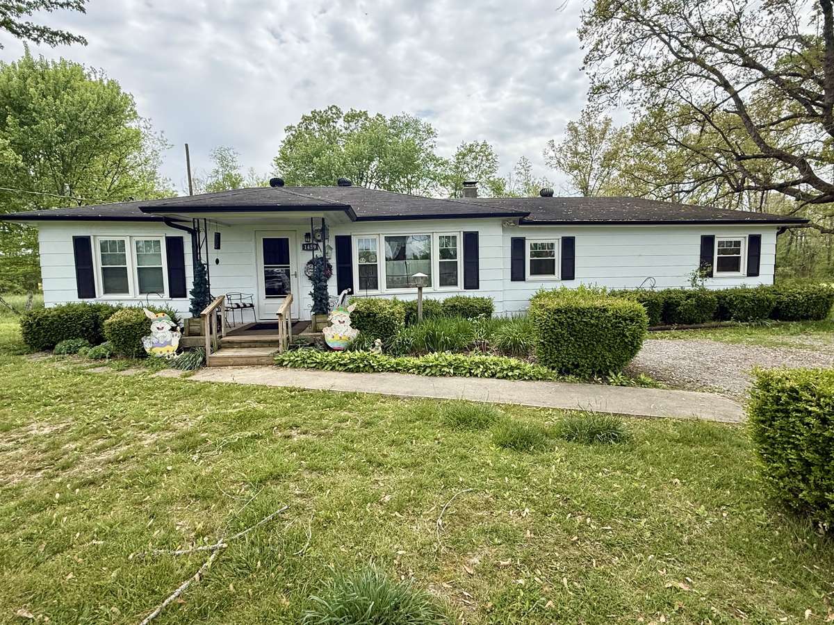 Charming 3 BR/2 bath house with covered porch and sidewalk leading to driveway.