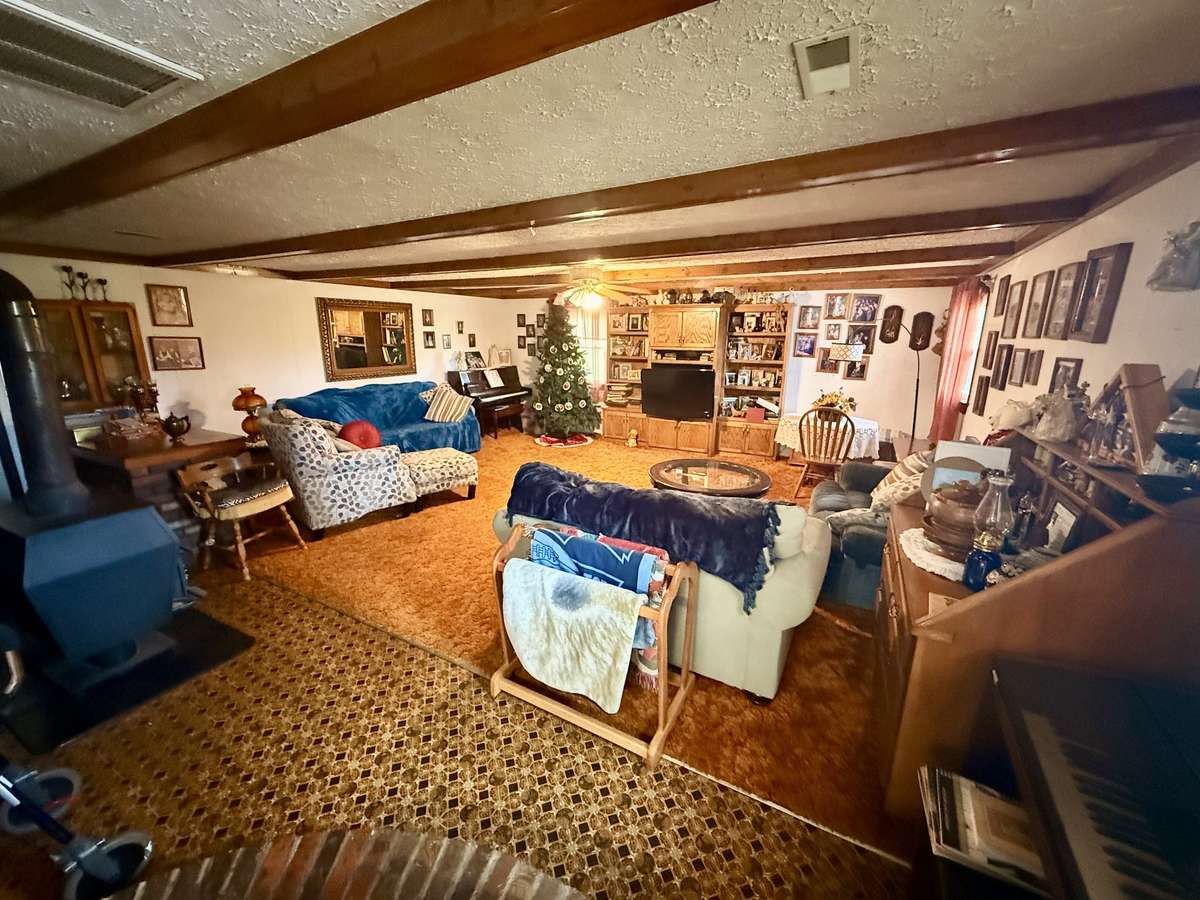 Spacious family room with beautiful wood beams and wood-burning stove.