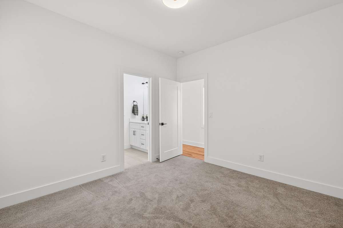 Secondary Bedroom features two closets and access to a Jack-and-Jill bathroom with tub/shower combination, double vanity and tile floors.