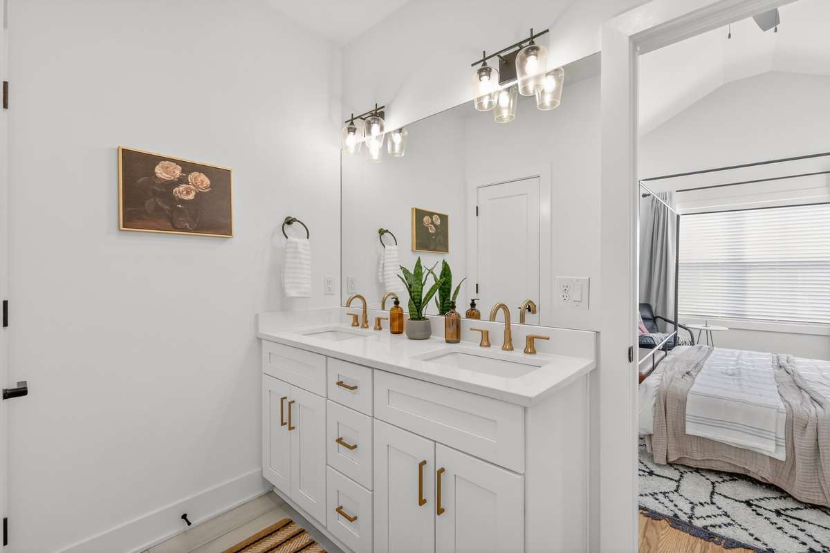 Private bath with double vanity and walk-in glass shower. Large walk-in closet. Private water closet and tile floor.