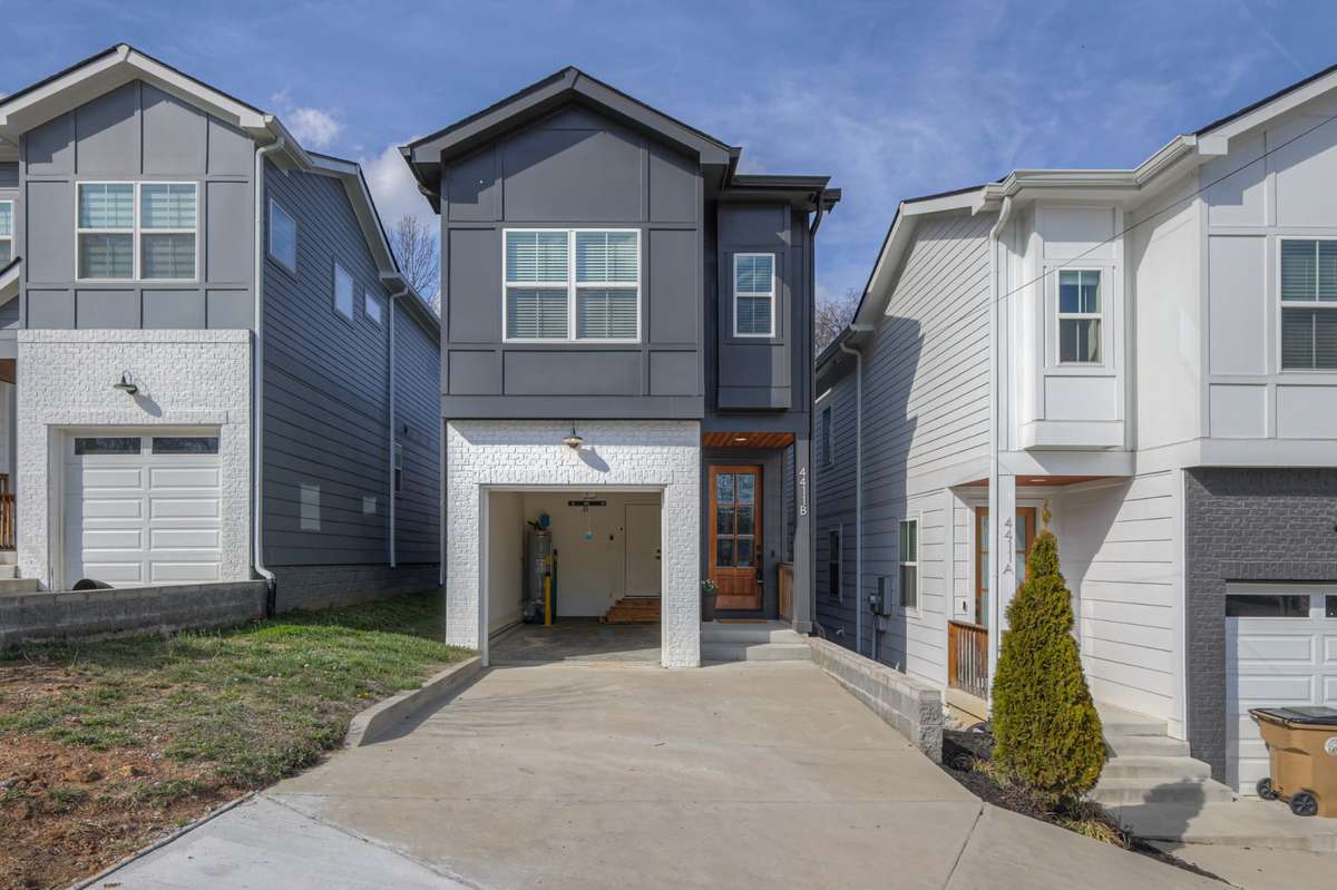 Photo of home with the garage door open.