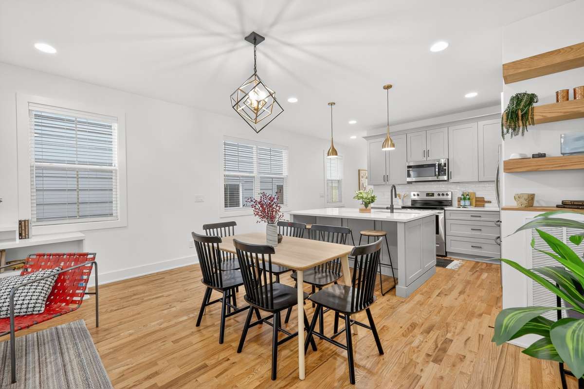 View of built in shelves and dining area into the kitchen.