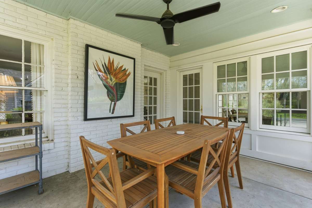 Side porch off of kitchen makes dining al fresco a breeze! Open up the door and have a cup of coffee or an easy meal outside!