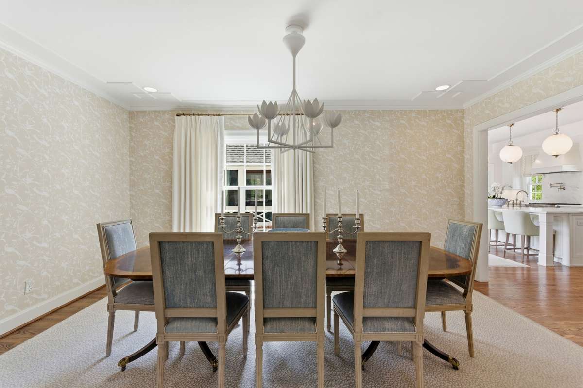 Formal dining room with Julie Neill for Visual Comfort chandelier and designer wallpaper.