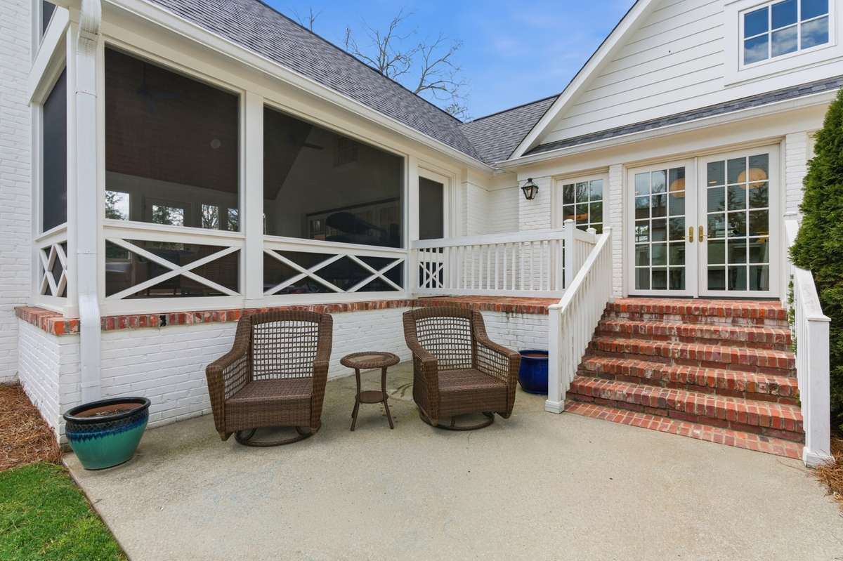 Back patio off of screened porch - open to backyard.