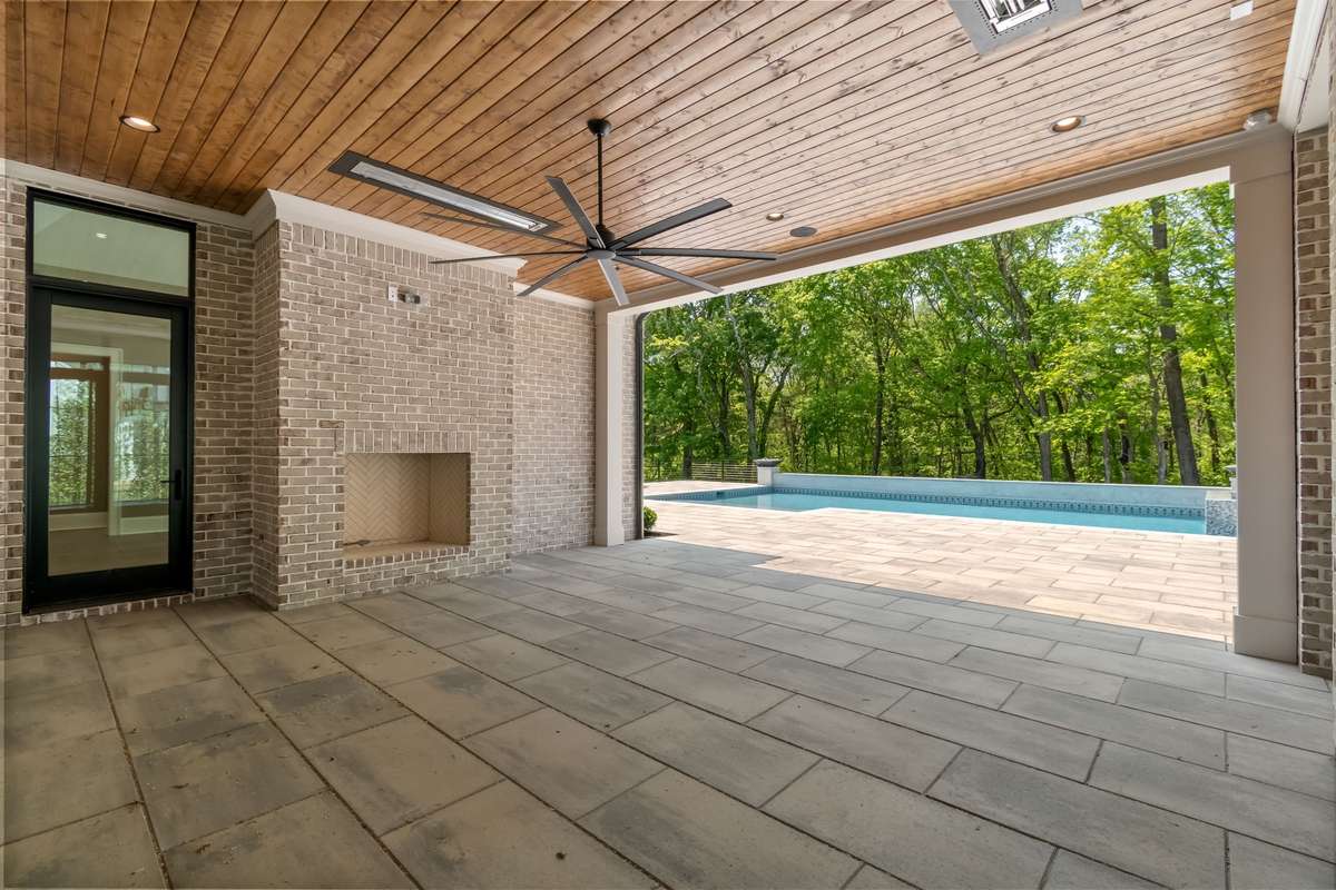 Rear Covered Porch with wood-burning fireplace.