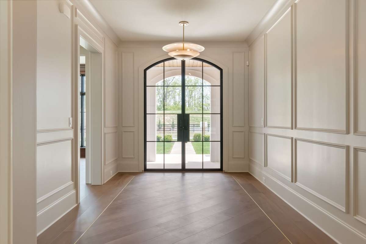 A grand foyer  with wall-to-wall wood detailing that invites you to explore the beauty within.