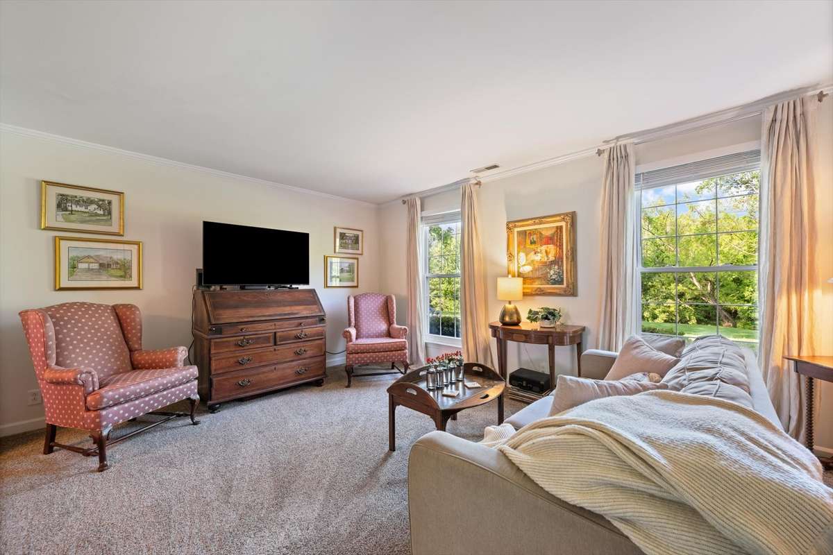 The formal living room has new carpet and faces the front of the home