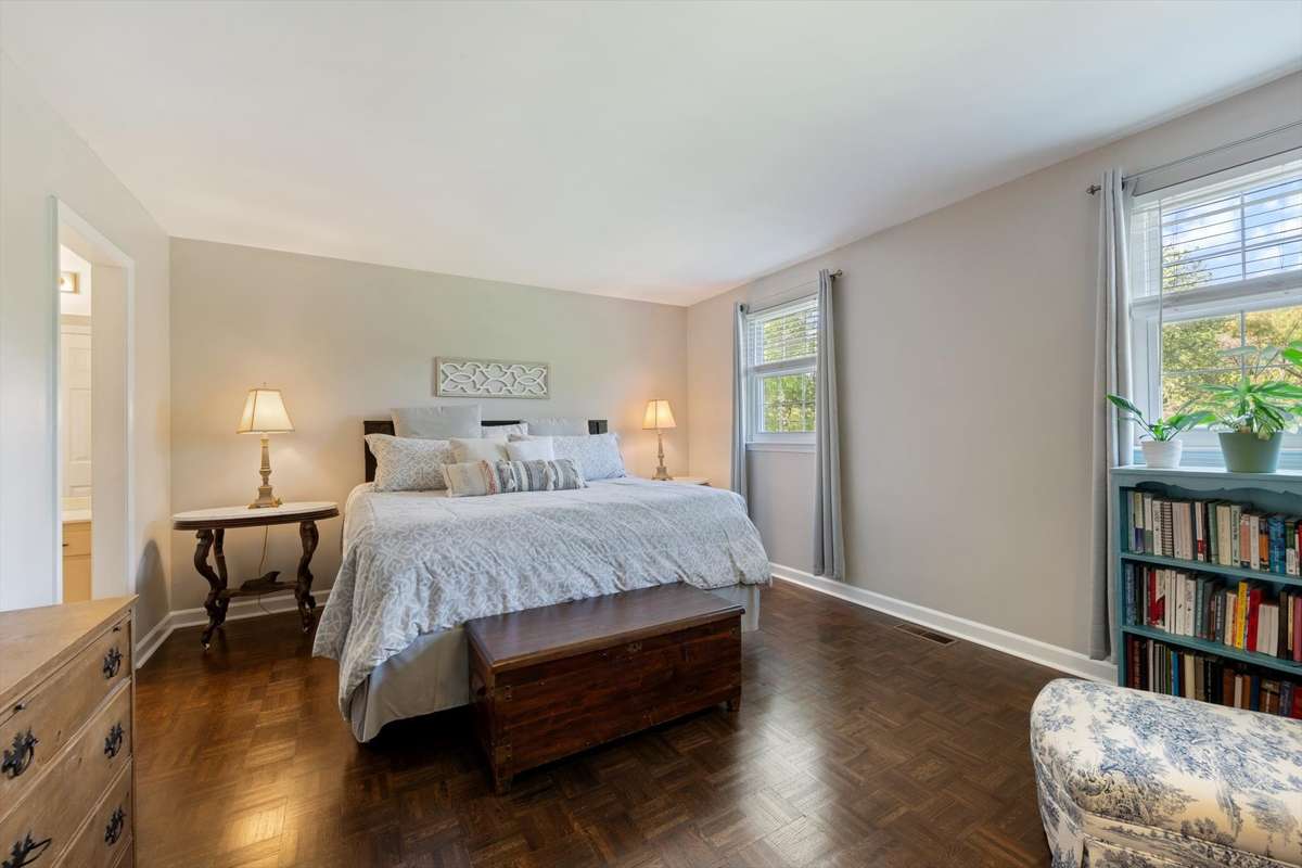 Upstairs, the spacious primary bedroom features recently stained, beautiful floors