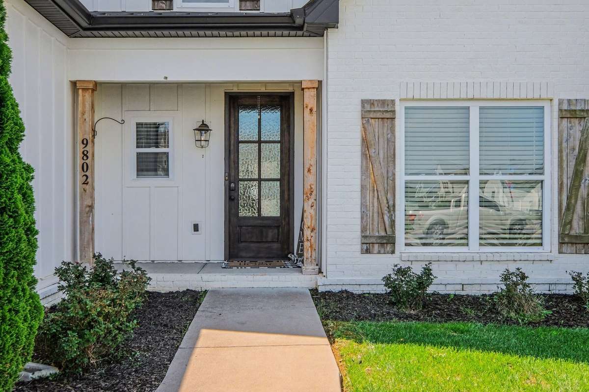 Welcome into this beautiful covered from porch with custom front door.