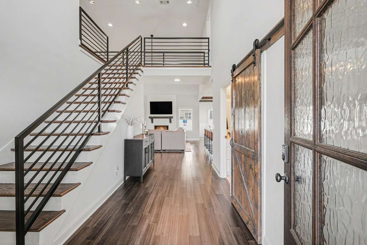 You'll love this foyer with the modern stair rails. There is another room on the main level to the right of the front door. Use it for a bedroom or an office!