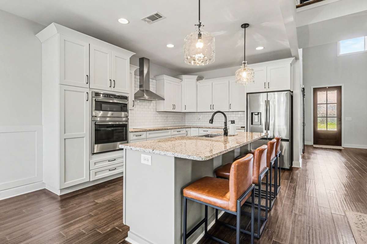 Notice the large pantry cabinet on the other side of the double ovens