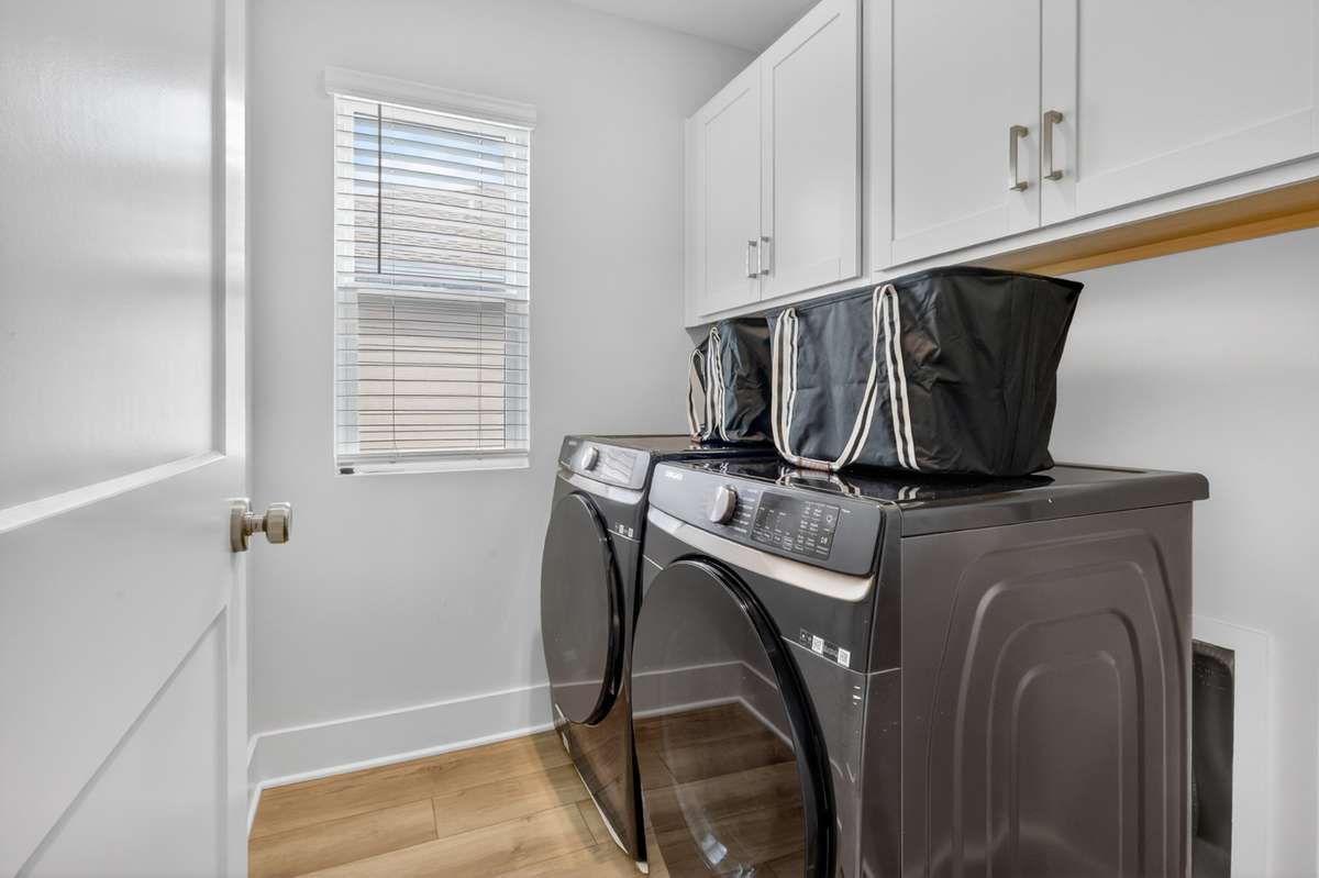 Laundry area featuring overhead cabinets for convenience and organization. *washer/dryer negotiable*