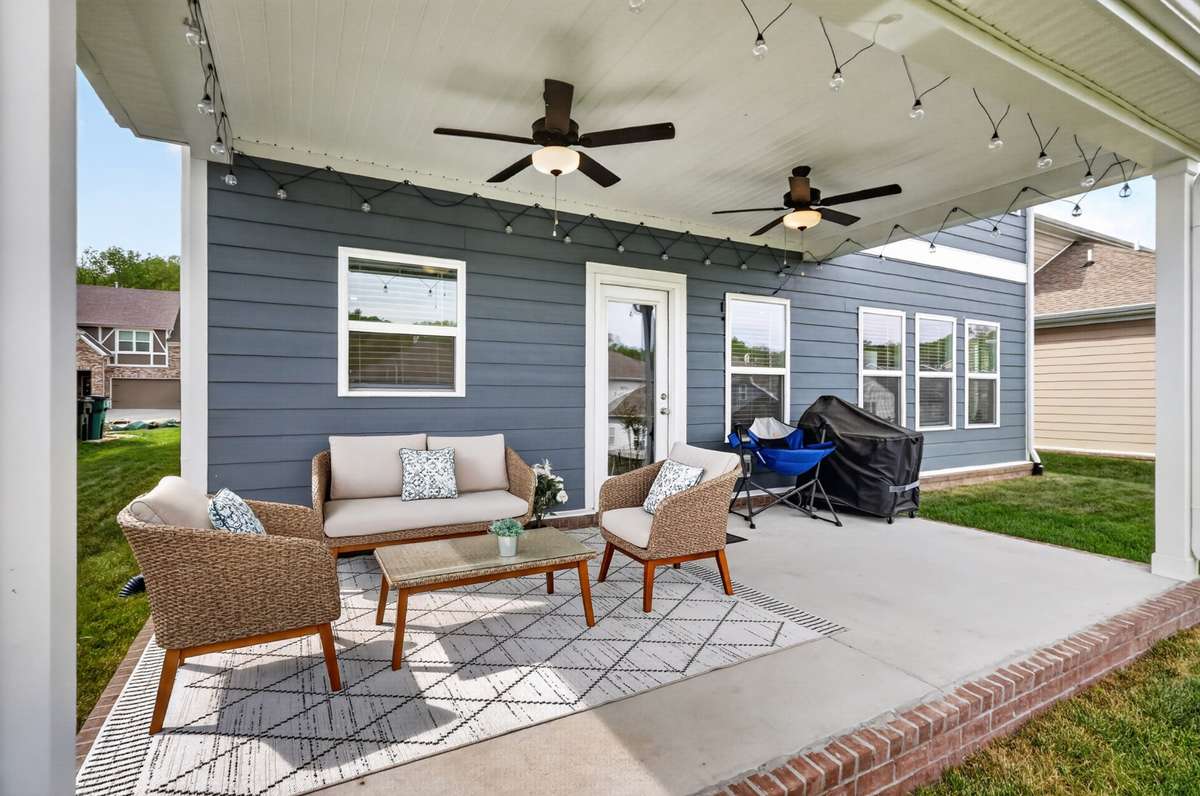 Covered outdoor patio with fans ideal for relaxing or hosting.