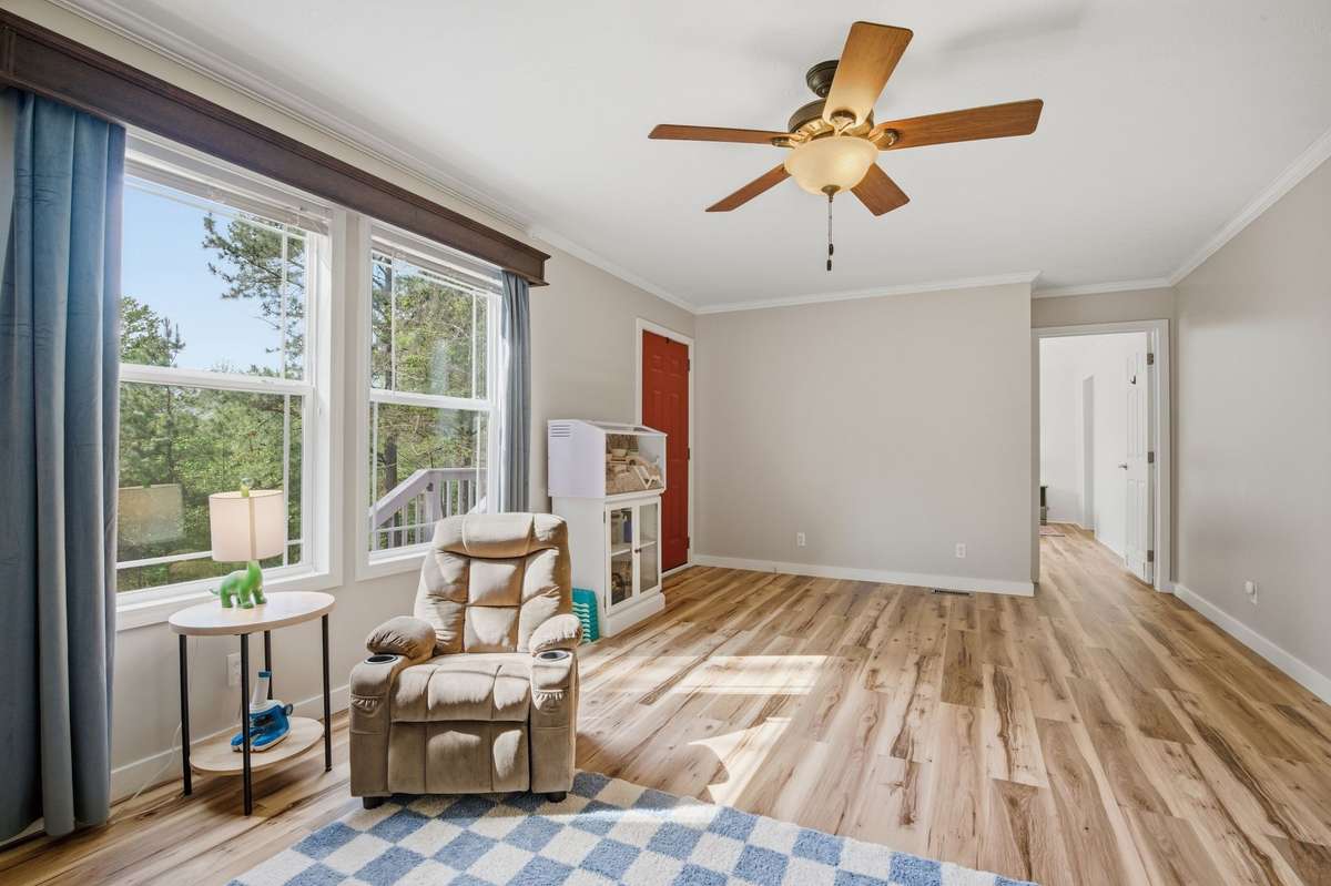 This giant den living area is right off the primary bedroom and front of the house!