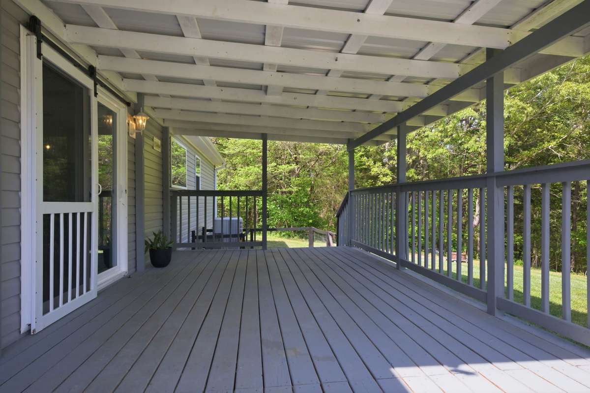 COVERED BACK DECK! (There is a fenced area off the deck for children or animals to play!)