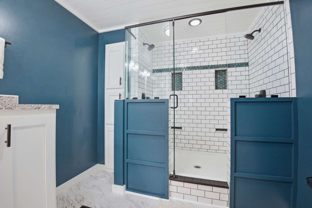Primary bathroom features a tile walk in shower with a glass door!