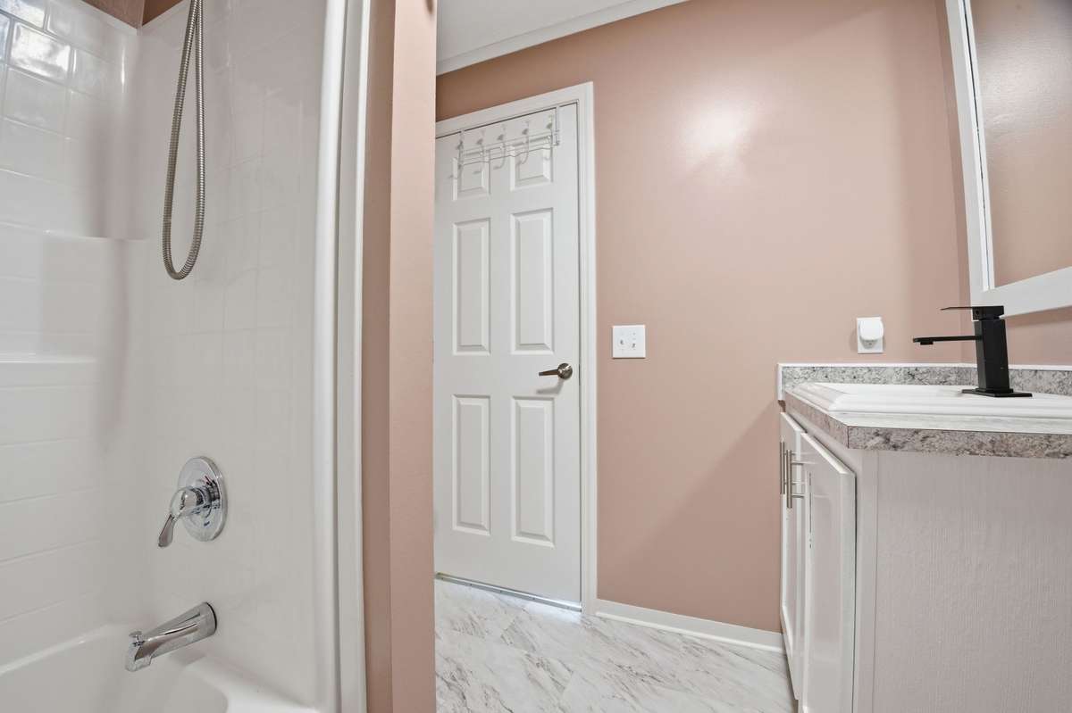 Combo shower and tub situated away from the vanity to allow for more space with getting ready!