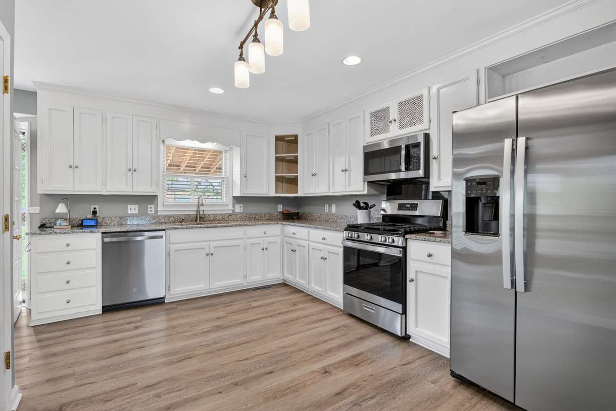 Fantastic kitchen with granite counters and new stainless steel appliances. The owner loves the gas stove.
