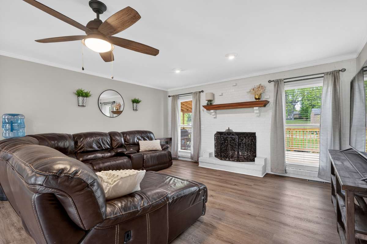 Wood-burning fireplace and lots of great natural lighting in the Den.