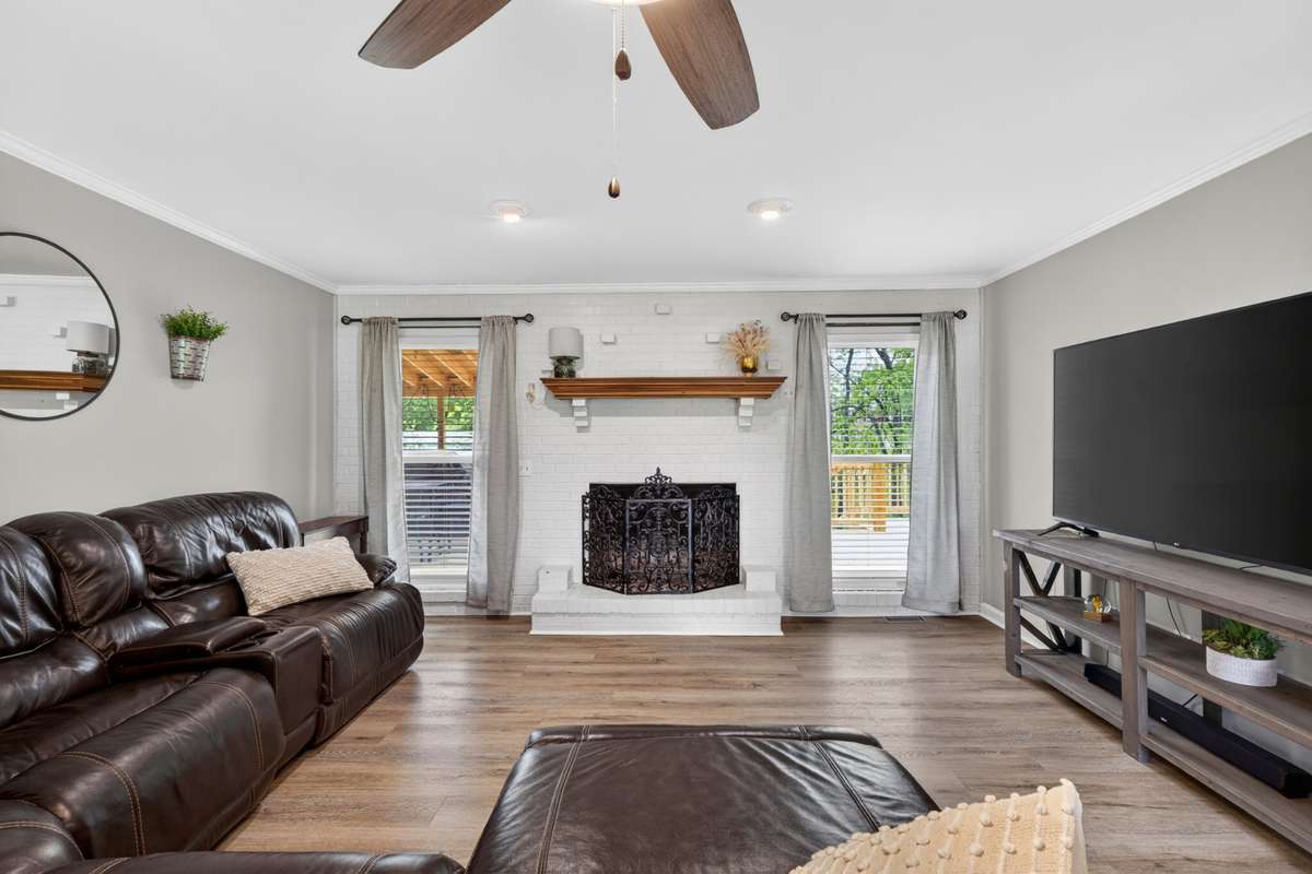Wood-burning fireplace and lots of great natural lighting in the Den.