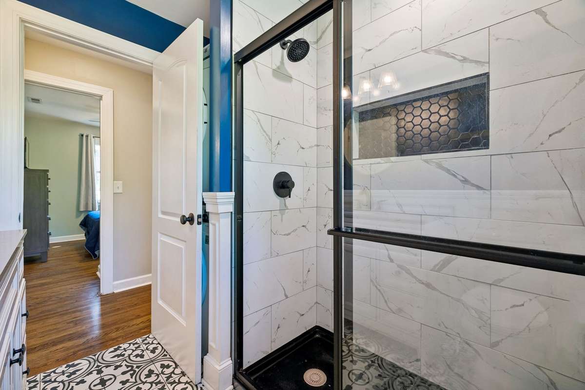 Spacious walk-in shower, creating a modern and luxurious feel. Includes convenient stackable washer and dryer.