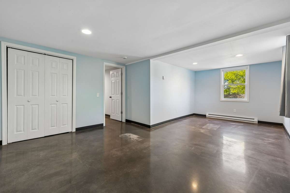 Huge bedroom in the finished basement offering flexible space for a king-sized bed plus a sitting area, sofa, or home office. Plenty of room for multiple uses while enjoying the privacy and comfort of the lower level.