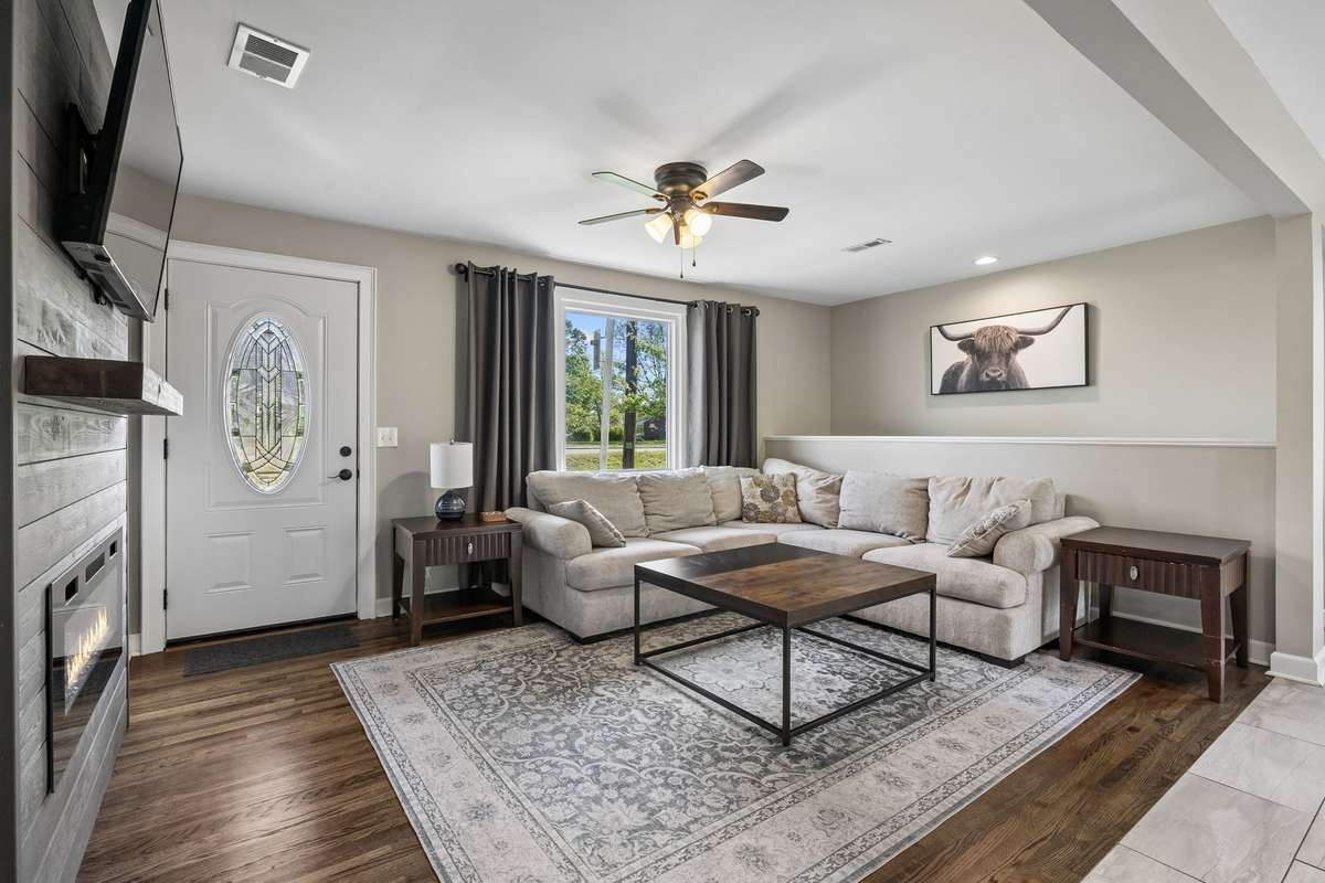 Spacious living room featuring gorgeous real hardwood flooring and excellent open-concept flow to the kitchen and dining areas.