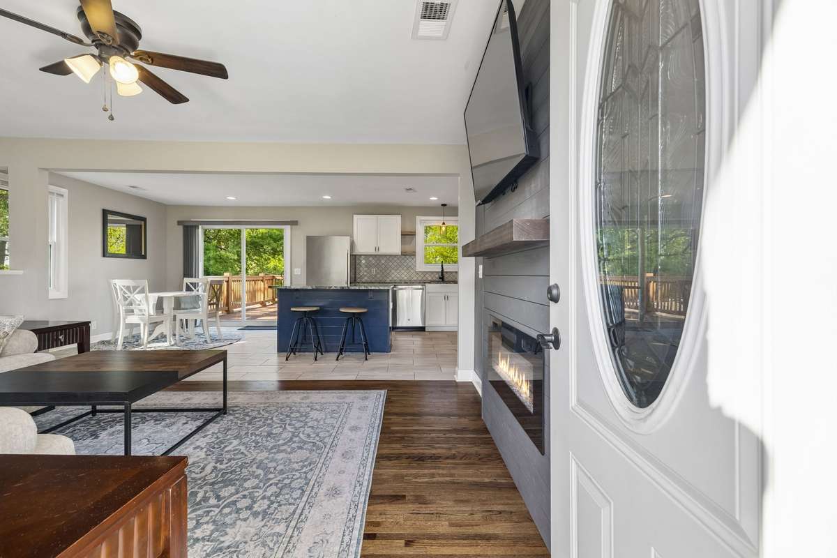 Inviting entry leads into an open floor plan with a beautiful shiplap accent wall, large TV, and electric fireplace in the living room.