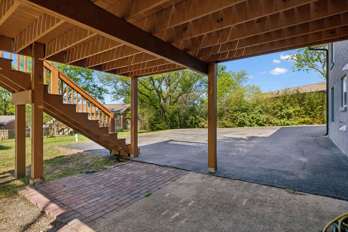 The expansive space also features a beautiful brick patio and overlooks the extra-large paved driveway, offering ample parking and exceptional curb appeal from every angle.