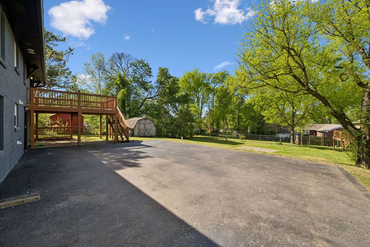Impressive newly constructed large deck overlooking a partially fenced backyard with a beautiful brick patio. Extra-large paved driveway provides convenient parking and added curb appeal.