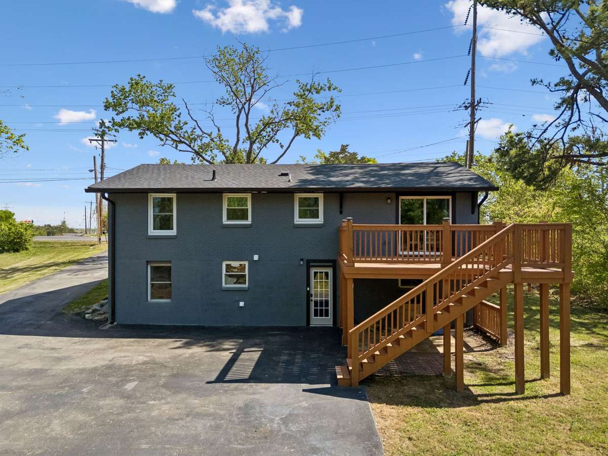 Breathtaking backyard view showcasing the massive newly built deck, perfect for outdoor entertaining and relaxation.